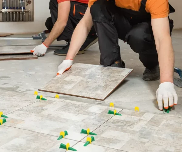 two-workers-are-installing-ceramic-tiles-floor-768x506-jpg