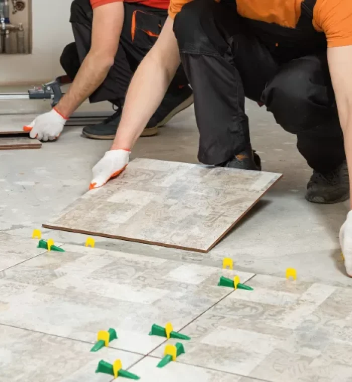 two-workers-are-installing-ceramic-tiles-floor-768x506-jpg